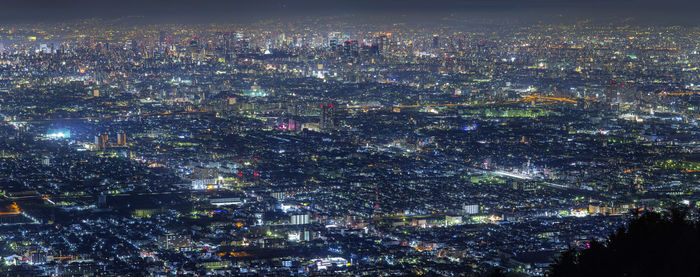 High angle view of city lit up at night