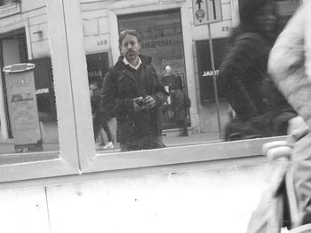 Portrait of woman standing by window