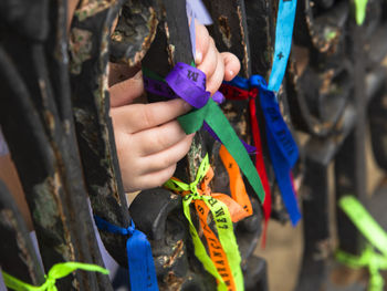Close-up of hands holding multi colored outdoors