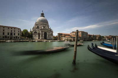 View of mosque at waterfront against sky