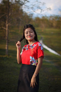 Portrait of woman standing on field