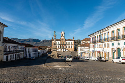 View of street amidst buildings against sky