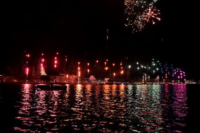 Illuminated firework display at night