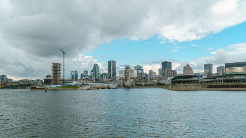 Panoramic view of river and buildings against sky