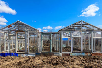 Built structure on field against blue sky