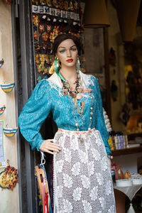 Portrait of woman standing at store