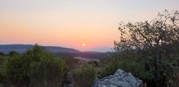 Scenic view of landscape against sky during sunset