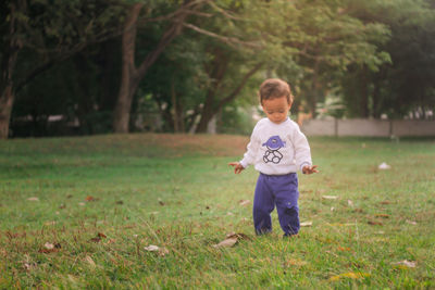 Full length of boy standing on field