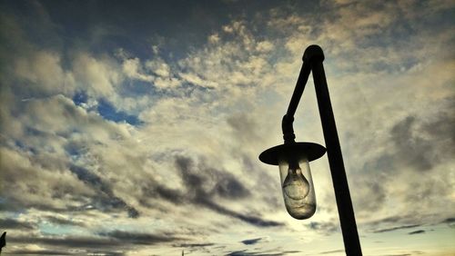 Low angle view of silhouette pole against sky