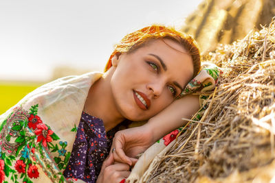 Portrait of smiling young woman lying down