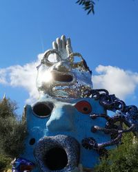 Low angle view of statue against blue sky