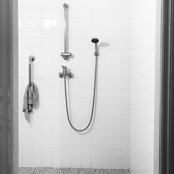 Close-up of a shower hanging on wall at home