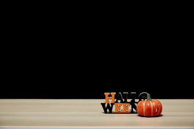 Close-up of toys on table against black background