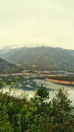 Scenic view of lake and mountains against sky