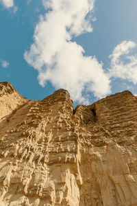 Low angle view of rock formations against sky