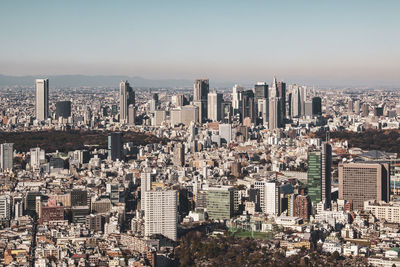 Aerial view of modern buildings in city against sky