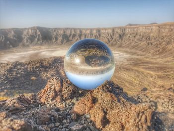 Close-up of crystal ball on rock