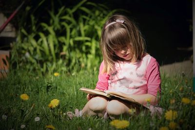 Girl reading book in garden