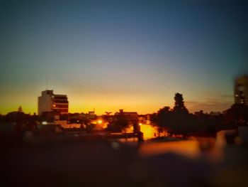 Cityscape against clear sky during sunset