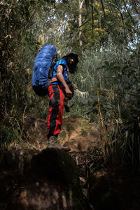 Men and big mountain backpacks in the woods