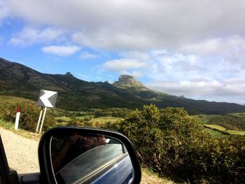 Side view of car against mountain range