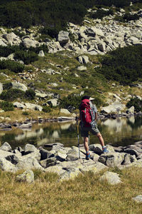 Woman standing on rock by lake