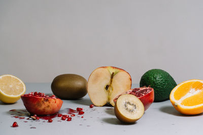 Close-up of fruits on table against gray background