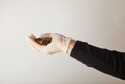 Close-up of woman hand against white background