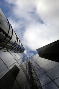 Low angle view of modern building against cloudy sky