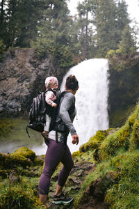 Rear view of man standing on rock