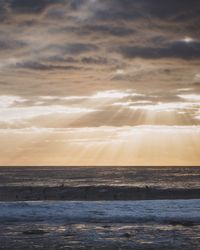 Scenic view of sea against cloudy sky