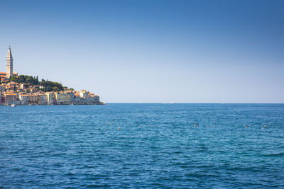 Scenic view of sea against clear blue sky