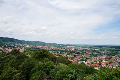 High angle view of houses in town against sky