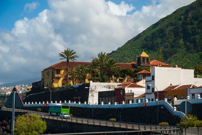 Buildings against cloudy sky