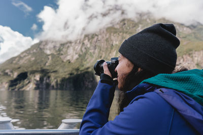 Portrait of man photographing water