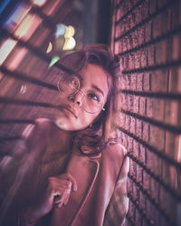 Young woman in nightclub seen through glass