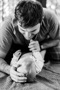 Rear view of man sitting in baby