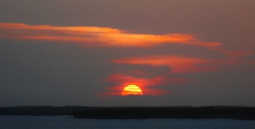 Scenic view of sea against romantic sky at sunset