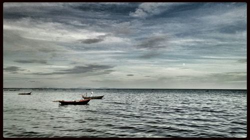 Scenic view of sea against cloudy sky