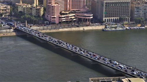 High angle view of bridge over river by buildings in city