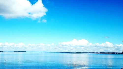 Scenic view of calm sea against cloudy sky