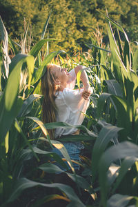 Woman with plants in field