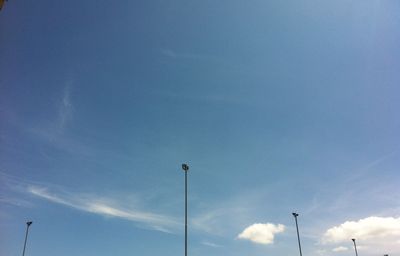 Low angle view of street light against blue sky