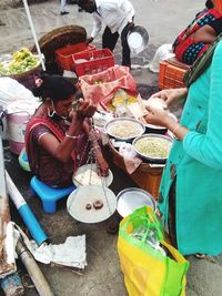 High angle view of people holding food at market