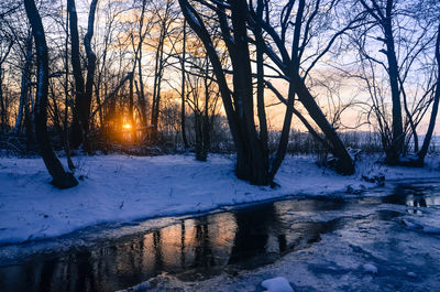 Snow covered landscape at sunset