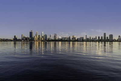 Modern buildings in city against clear sky