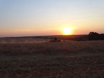 Scenic view of field against sky during sunset