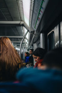Rear view of people sitting in train