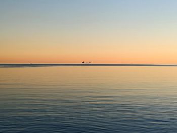 Scenic view of sea against clear sky during sunset