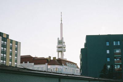 Buildings in city against clear sky